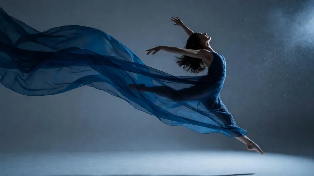 Dancer in motion with blue rim light and flowing fabric
